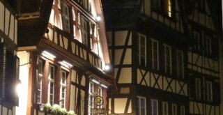 beleuchtete Fachwerkhäuser bei Nacht in Straßburg im Winter